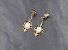 A pair of 9ct gold stud earrings having faux opal set drops in open mounts, approx 1.4g