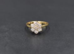 An 18ct gold diamond cluster ring, the floral motif cluster having a total diamond weight of