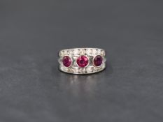An 18ct white gold ruby and diamond open band ring, having three central rubies, total approximately