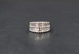 An 18ct white gold diamond five row shaped band ring having two rows of baguette cut diamonds