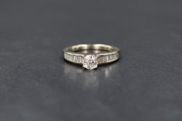 A 14ct white gold diamond solitaire ring, the bright cut diamond, approx 0.5ct in a raised 4 claw
