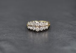 An 18ct gold diamond ring, the two rows of seven graduated round cut diamonds measuring from