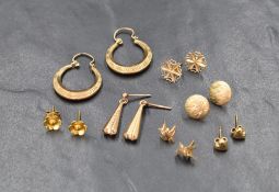 Seven pairs of 9ct gold and yellow metal earrings for pierced ears, including hoops, floral,