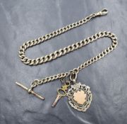 A silver curb link watch chain, having dog clip and T-bar along with a silver shield charm, 56.2g