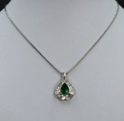 A white and yellow metal emerald and diamond necklace and earrings, the necklace having a central