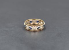 A 9ct gold full eternity ring having sapphire and white paste stones in collared mounts within