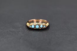 An Edwardian 9ct rose gold and turquoise ring having five graduated turquoise cabochon stones in a
