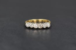 An 18ct gold diamond half eternity ring, having six claw set diamonds, total approx 1ct on an 18ct