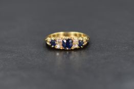 An 18ct gold sapphire trio ring having three graduated sapphires, total approx 0.375ct, interspersed
