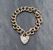 A silver curb link bracelet, having a silver heart padlock and safety chain, 41.3g. Padlock does not