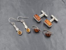 A pair of silver amber drop earrings, the bezel set oval amber cabochons with hook back, along