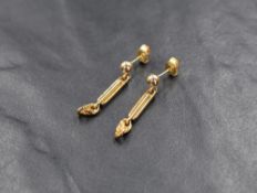 A pair of 9ct gold earrings having a gold stud with a bar and chain drop, approx 2.2g