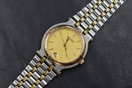 A Gucci wristwatch, the golden dial having baton numerals and date aperture, on a two tone stainless