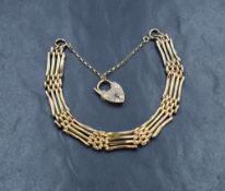 A 9ct gold four bar gate bracelet, having a heart padlock clasp with safety chain, 10g
