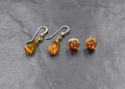 A pair of 9ct gold amber stud earrings, of circular form having a gold surround, along with a pair