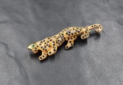 A diamond and gem set 18ct gold panther brooch, the body pavè set with brilliant-cut diamonds and