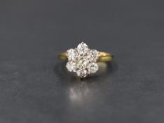 A seven stone brilliant cut diamond daisy cluster ring, total approx 1.35ct in a raised claw set