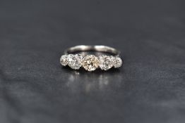 A platinum five stone diamond ring, the graduated diamonds measuring between approximately 0.33ct