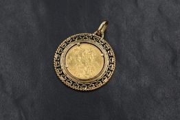 A George V 1912 sovereign, in a 9ct gold meander pattern surround mount with pendant loop, 13.4g