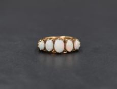 A 9ct gold five stone opal ring, the graduated oval opal cabochons in a scroll gallery, ring size