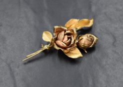 An 18ct gold floral spray brooch, in the design a two rose stems, having an open flower and rose