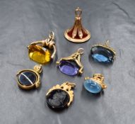 A collection of 9ct gold and yellow metal fobs, five of spinner form and two of standard, two having