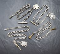 Four silver and white metal watch chains, three having T-bars and silver shield charms, 120.6g