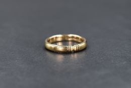 A 9ct gold band, having decorative engraving, ring size J-K, 2.5g