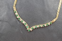 A yellow metal emerald and diamond set necklace stampe 14K -585, the emeralds and diamonds being set