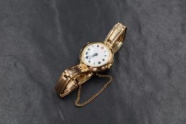 A 9ct gold wristwatch, the white dial having Roman numerals, on a 9ct gold bracelet strap, 21.6g