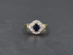 An 18ct gold sapphire and diamond cluster ring, the central oval cut blue sapphire in an illusion