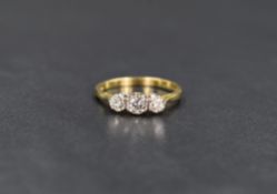 An 18ct gold diamond trilogy ring, the graduated diamonds measuring between approximately 0.20ct and