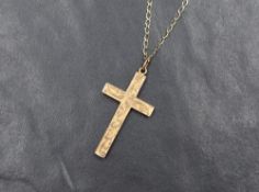 A 9ct rose gold cross pendant having engraved decoration on a later 9ct gold open link chain, approx