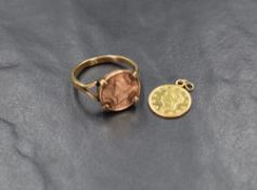 A US one dollar coin, mounted in a yellow metal ring having split shoulders marked 9ct, ring size