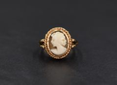 A 9ct gold cameo ring, the bezel set cameo depicting a maiden in profile in a decorative mount