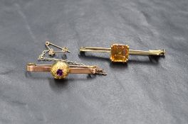 An early 20th century 9ct gold amethyst brooch, the central bezel set amethyst in a closed back
