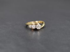 An 18ct diamond trilogy ring having three old cut stones in a cascade style, approx 0.75ct total