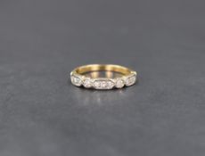 An 18ct gold and diamond half eternity ring having eleven small diamonds in a shaped mount, size K &