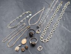 A vintage plastic case containing a small amount of silver and white metal jewellery including