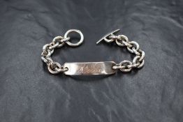 A 1970's silver ID bracelet of stylised heavy form bearing name: Sheila to name plaque and having