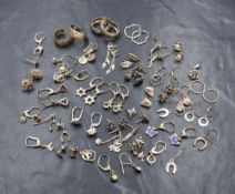 A vintage plastic case containing a large selection of silver and white metal earrings (for