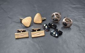 A pair of onyx and seed pearl cufflinks, the rectangular panels having a central seed pearl, with
