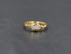 An 18ct gold and diamond trilogy ring having three diamond chips in illusionary settings to open