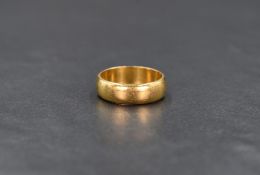 A 22ct gold band, of plain form, ring size L, 6.1g