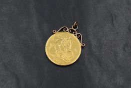 A Victorian 1887 Royal Mint double sovereign, in an unmarked yellow metal scroll mount with