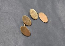 A pair of 9ct gold cufflinks, the oval panels having 'JH' monogram to one side with chain