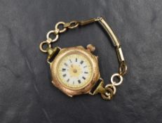 A 14ct gold top wound modified pocket watch, the white dial having Roman numerals with gold tone