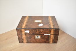 A 19th century walnut jewellery box, decorated having geometric patterns and mother-of-pearl inlays,