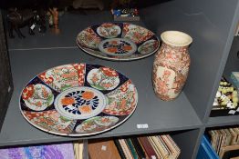 An attractive large pair of Japanese Imari chargers, hand decorated with foliage in blue, green