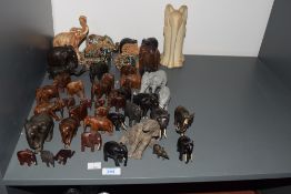 A large group of wooden elephants, to include a pair of ceramic salt and pepper elephants, ect, ( 48